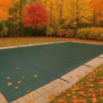 PSP solid safety pool cover installed on a backyard pool in Toronto surrounded by autumn leaves