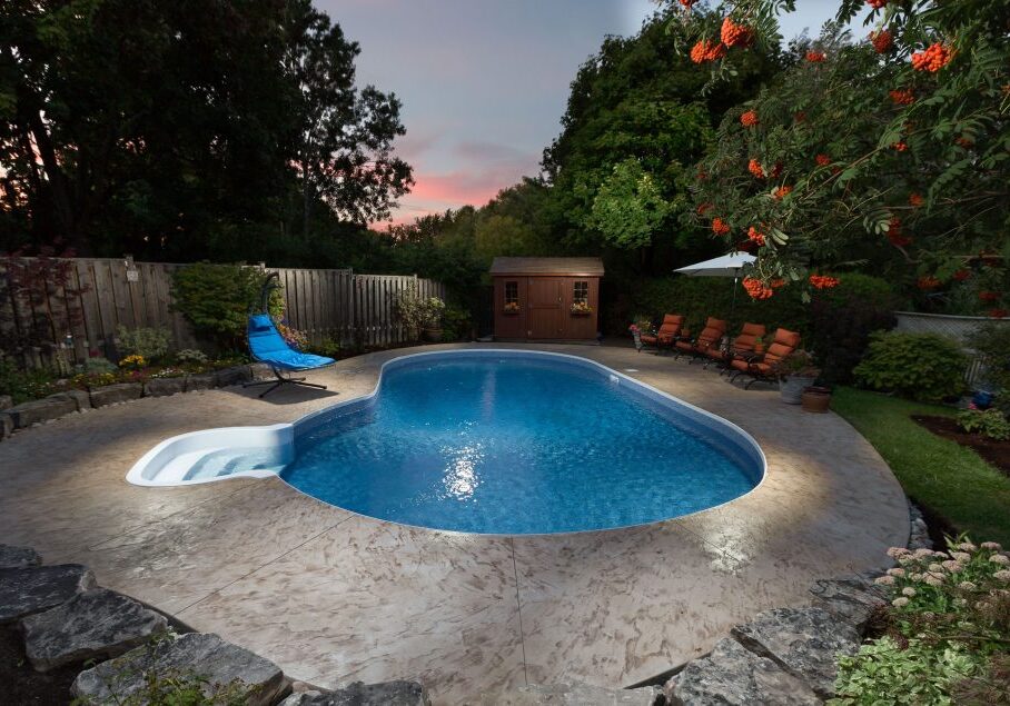Along the back, there is a retaining wall.  Between the deck and the retaining wall, river rock was laid so that the drainage runs into the stone and out the drainage system