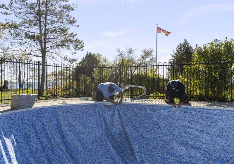 Bremner Pool & Spa technicians installing a vinyl pool liner during an inground pool liner replacement in Toronto.